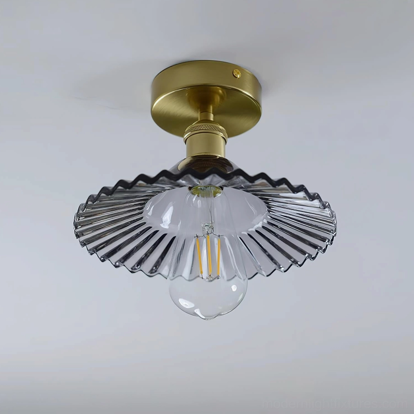 Amber Kinney ceiling light fixture with wavy glass shade in vintage-inspired interior setting