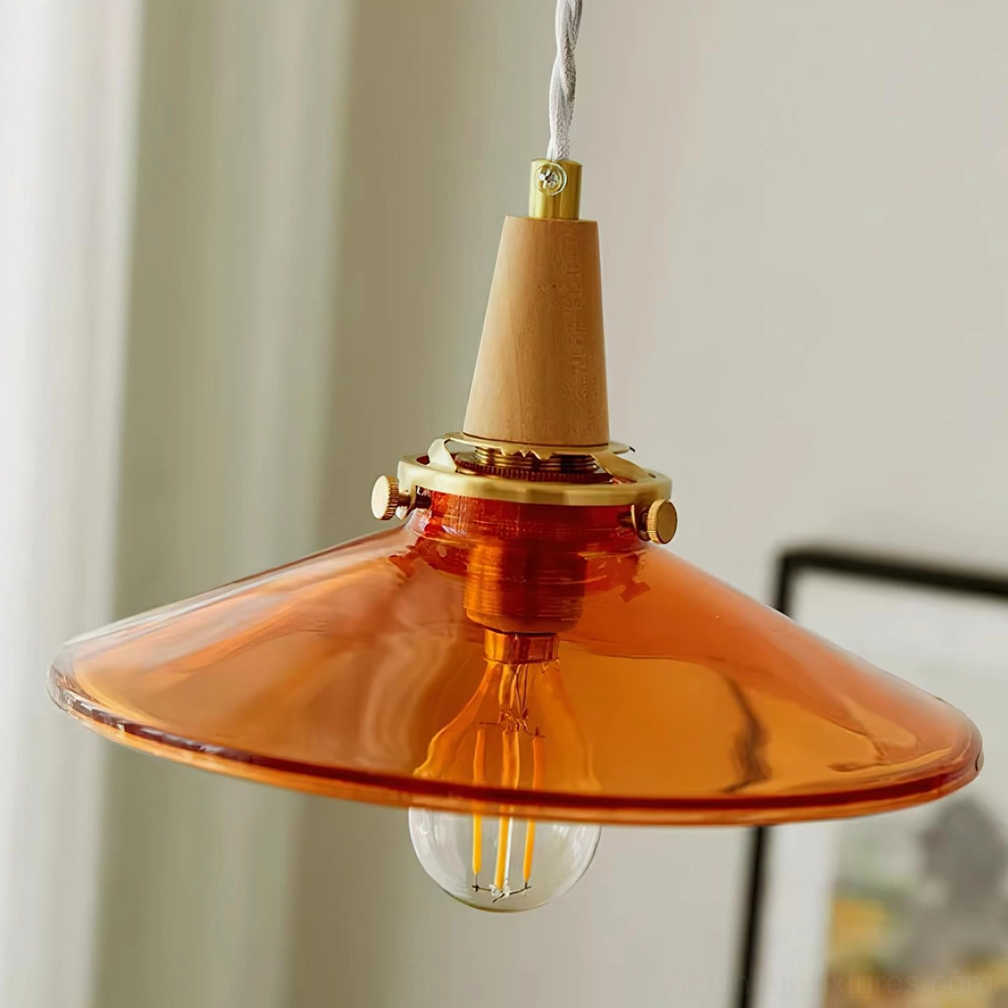 Amber pendant light fixture mounted in interior space showing color and finish combinations