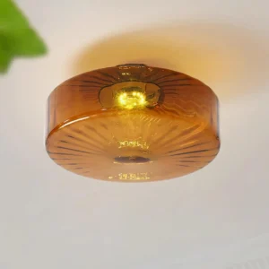 Amber Razia modern ceiling light overhead view showing even warm light distribution through amber glass