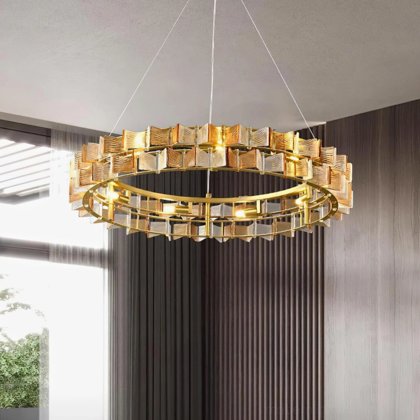 Warm amber glass ring chandelier hanging in modern bedroom with wooden accent wall warm lighting