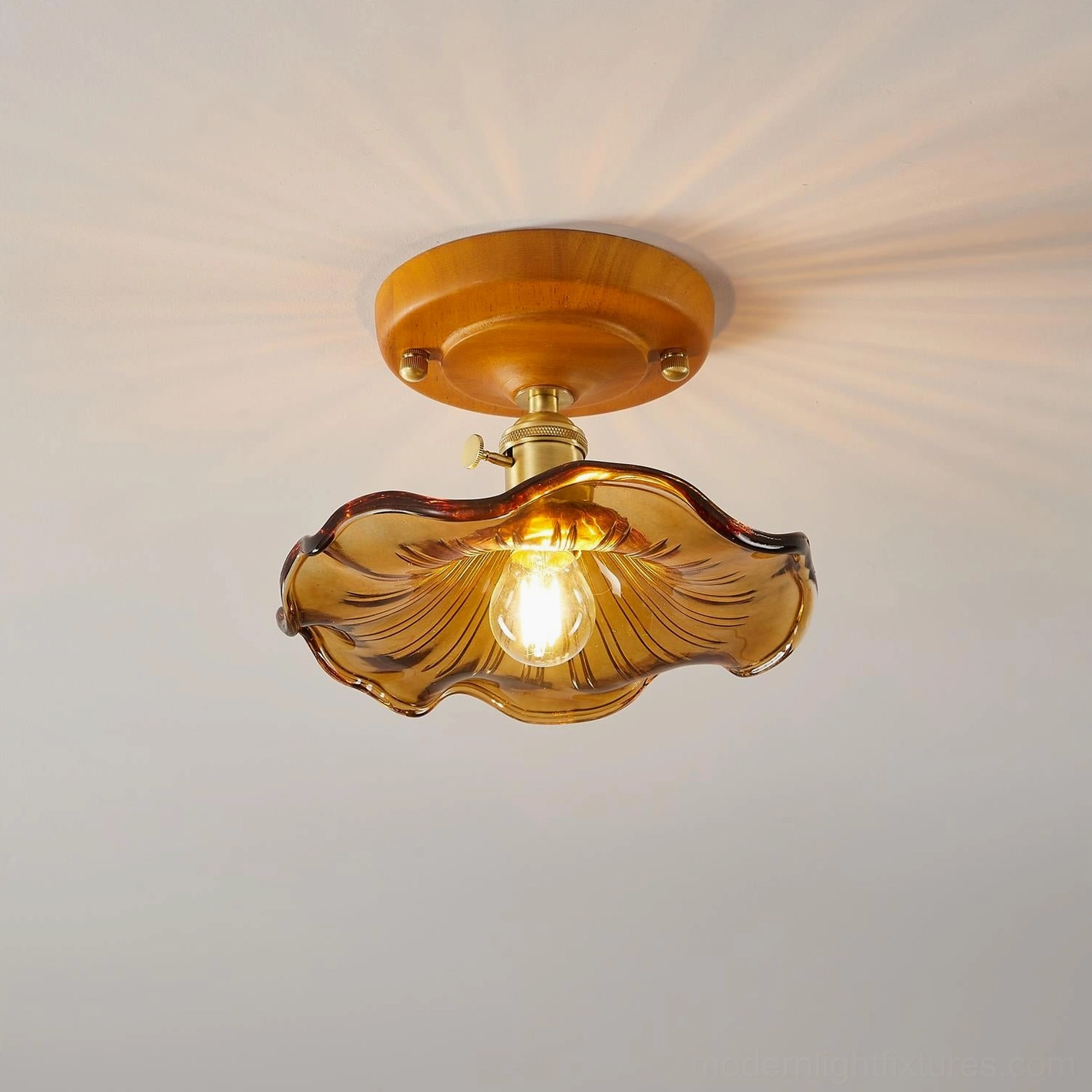 Warm amber wave-textured ceiling light showing glass ripple detail and soft illumination