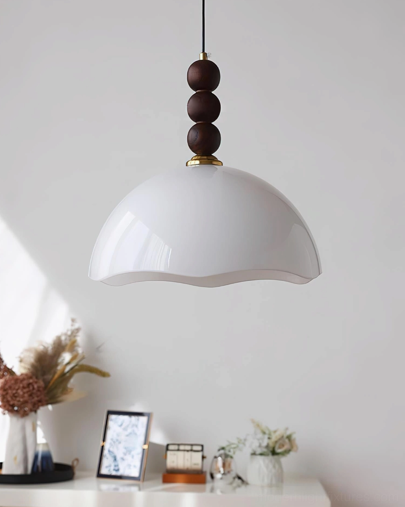 Amber rippled glass pendant light with organic walnut bead accent creating warm ambiance in café setting