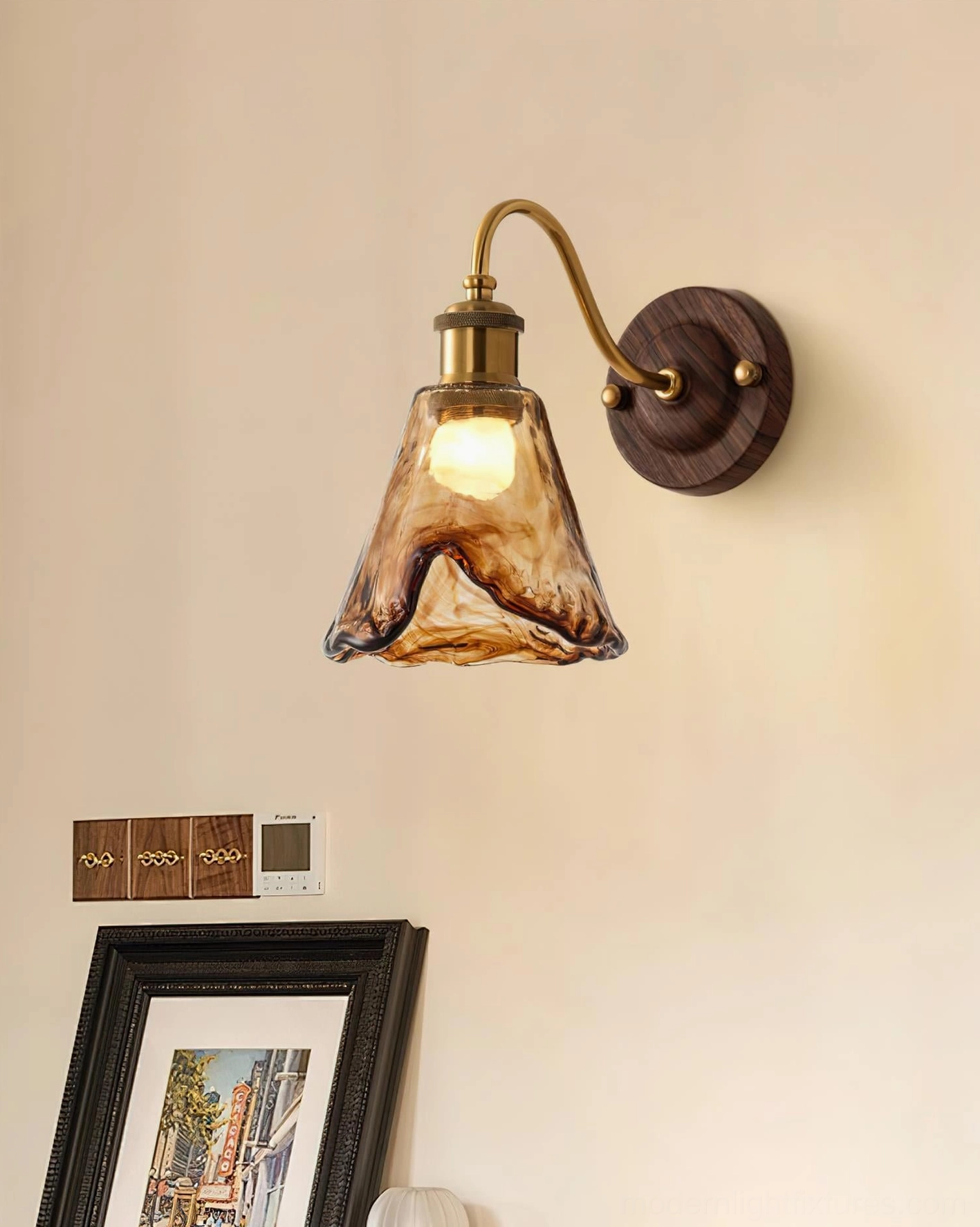 Nalia amber wall lamp installed above bedroom bedside table creating intimate warm ambiance