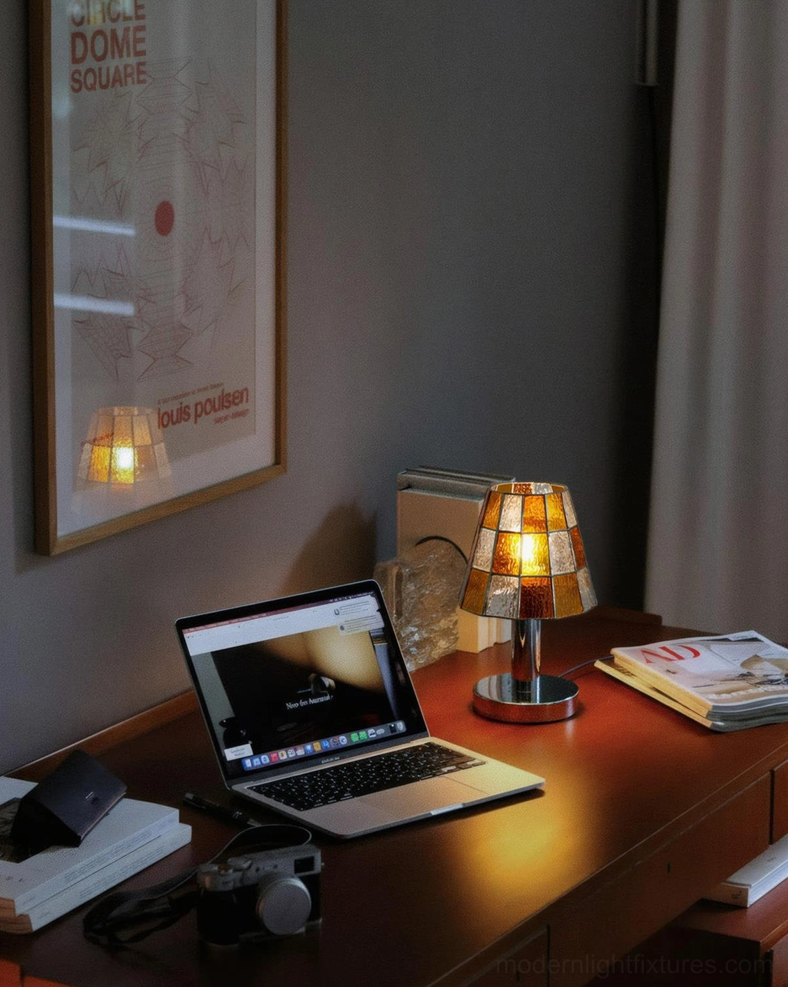 Warm amber glass table lamp creating intimate home office desk lighting on wooden work surface