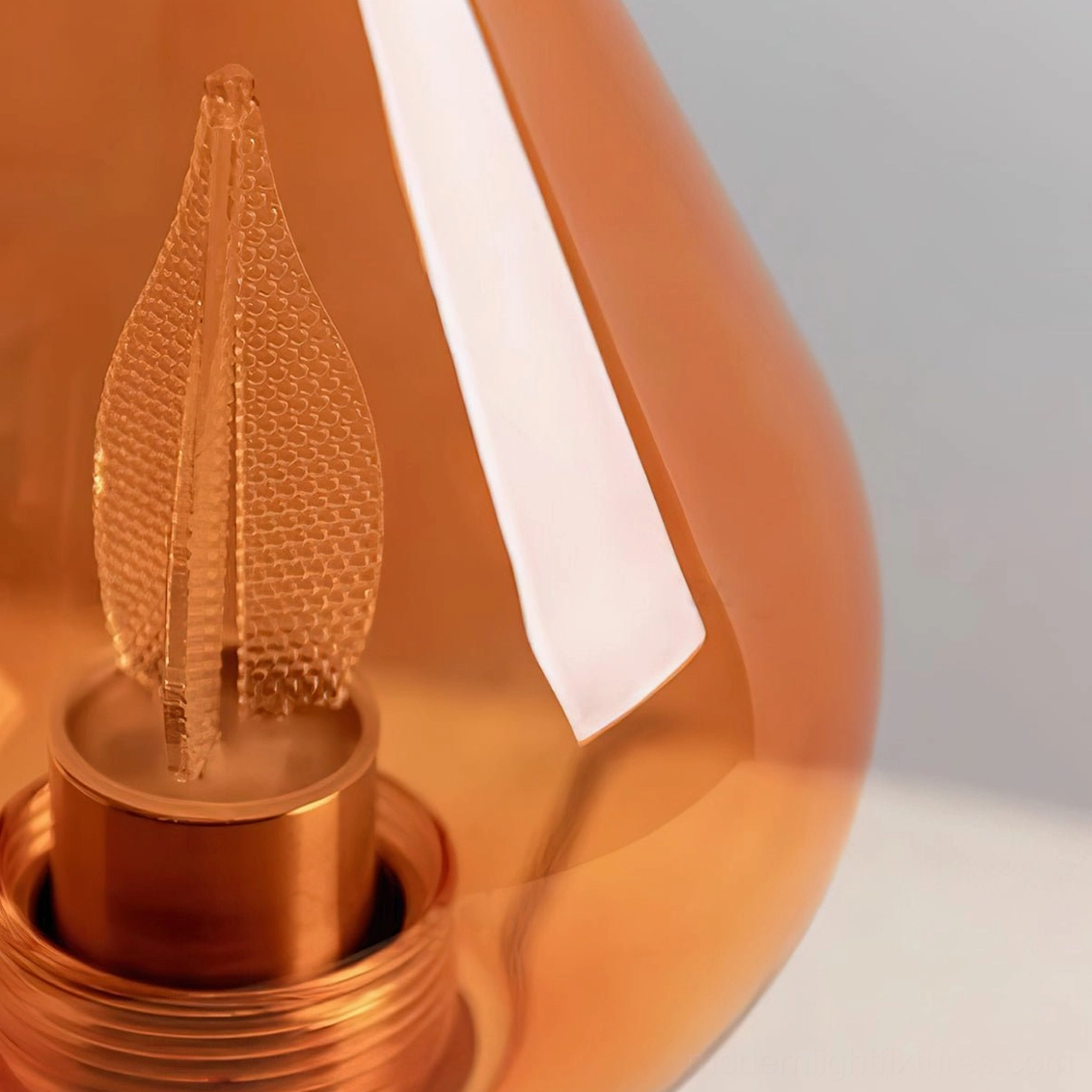 Amber teardrop LED table lamp in contemporary home setting, showcasing warm light quality and sculptural design as functional art piece