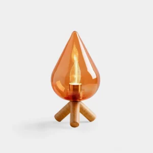 Amber teardrop LED table lamp with solid wood tripod base on white background, front view showing warm glass shade and modern minimalist design