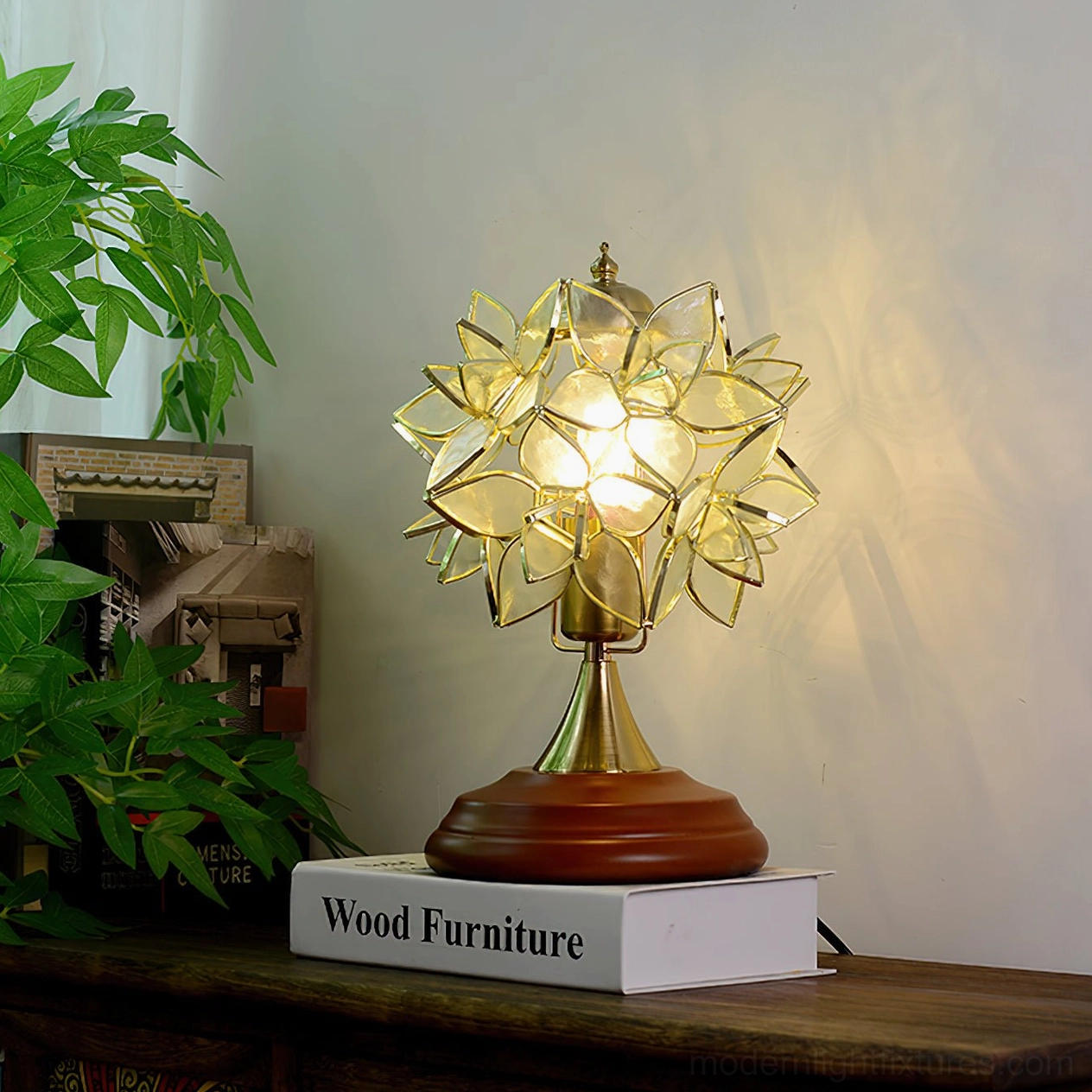 Amber stained glass Tiffany table lamp with brass hardware and solid wood base on wooden furniture