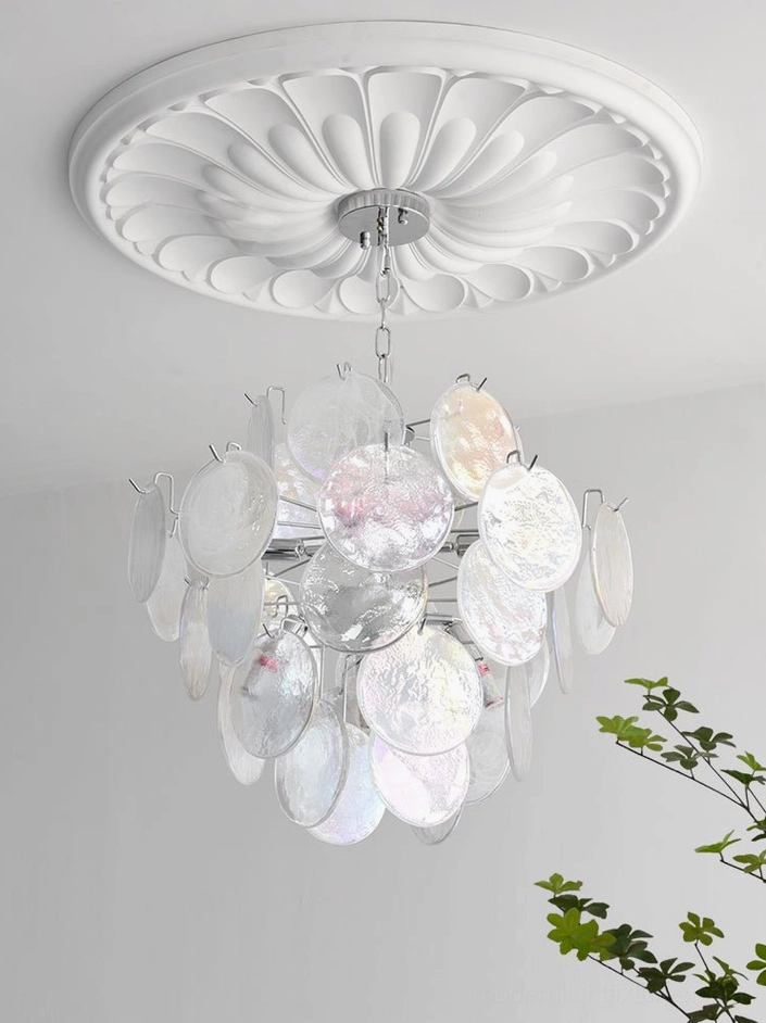 Warm white light glowing through iridescent glass disc chandelier showing ambient effect