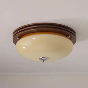 Amelia flush mount ceiling light mounted on indoor ceiling with multi-layer walnut wood base and rounded glass diffuser