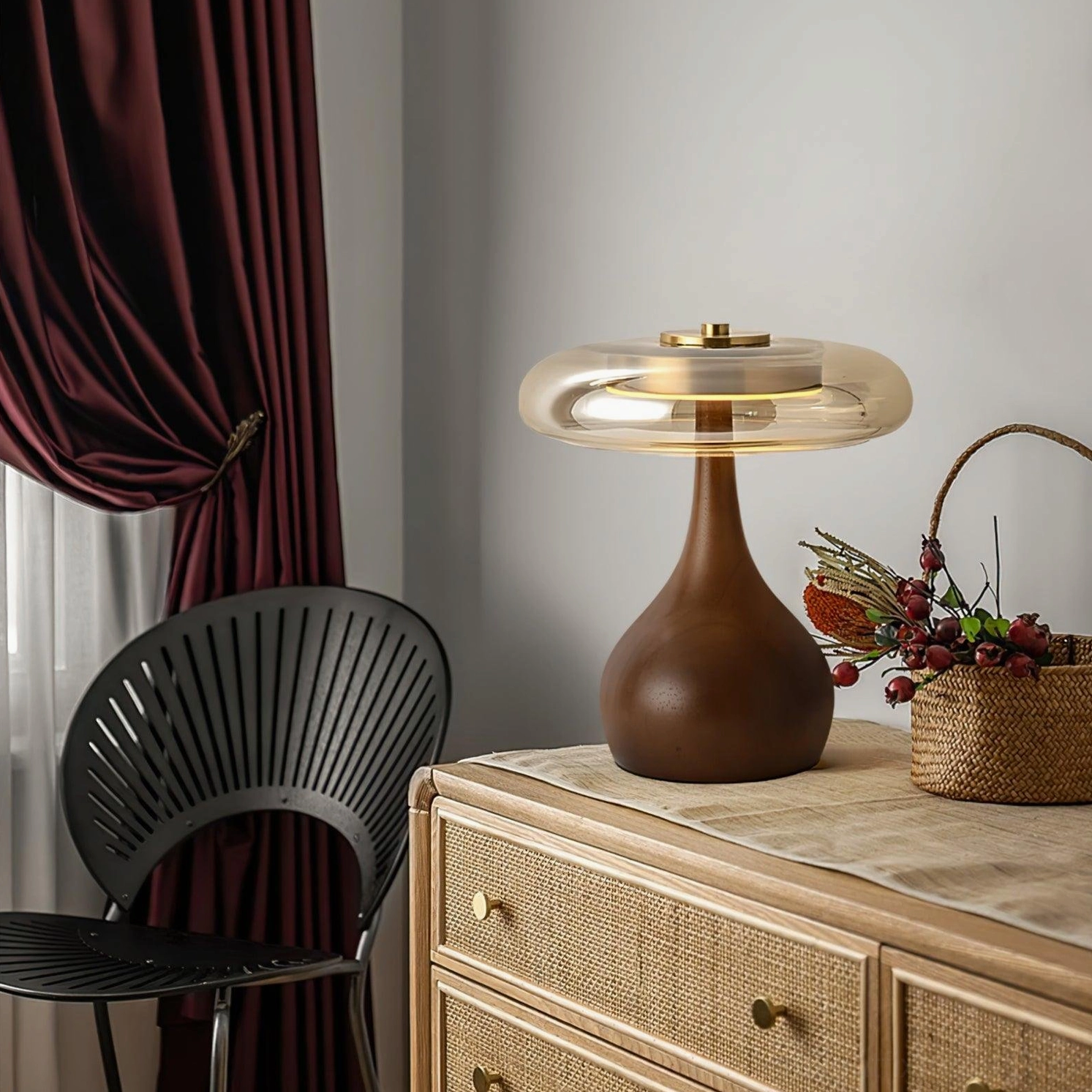 Andi modern glass lamp on bedroom dresser corner with dark red curtains and woven basket