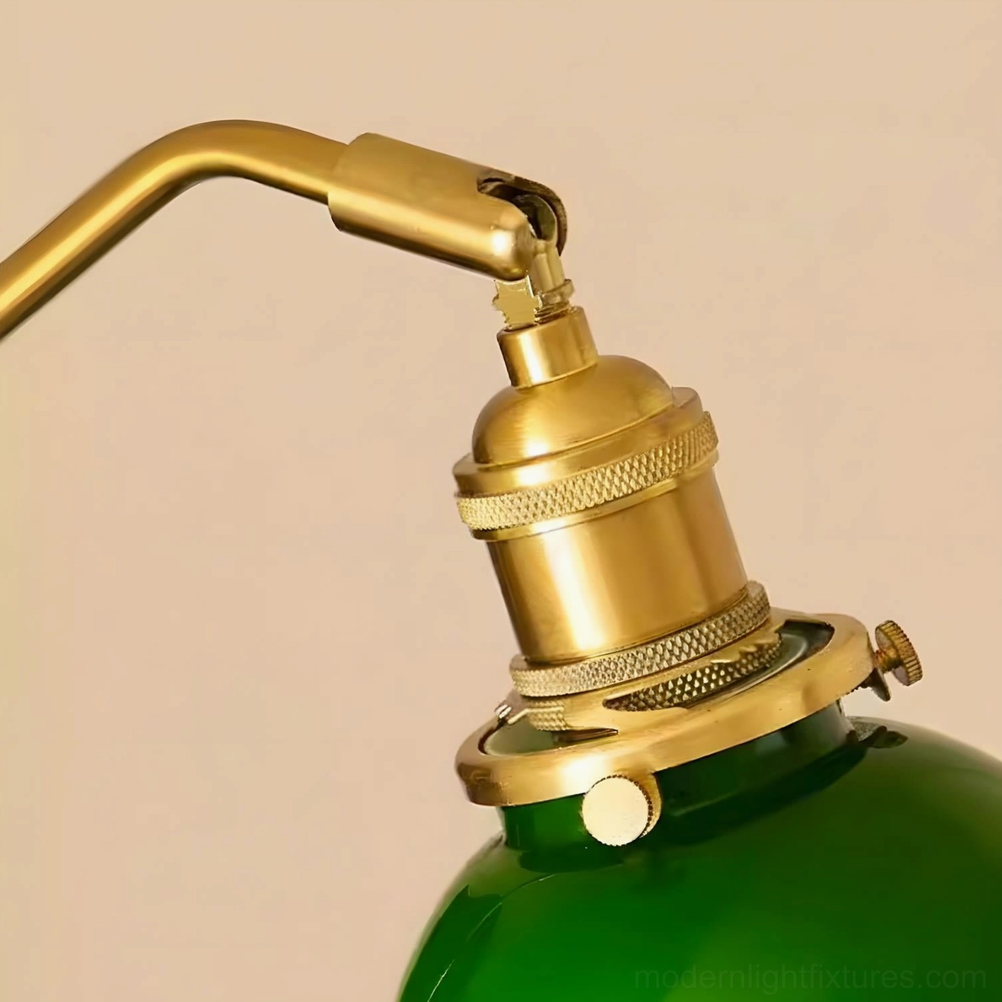 Antique-inspired wall sconce with rich emerald glass shade illuminating vintage interior space