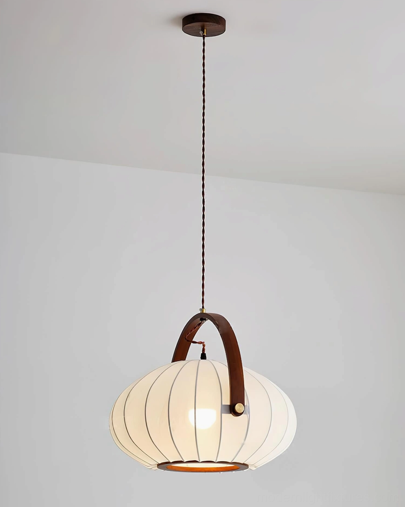 Antonio fabric pendant lamp in warm white modern interior, showing pleated lantern silhouette and soft glow