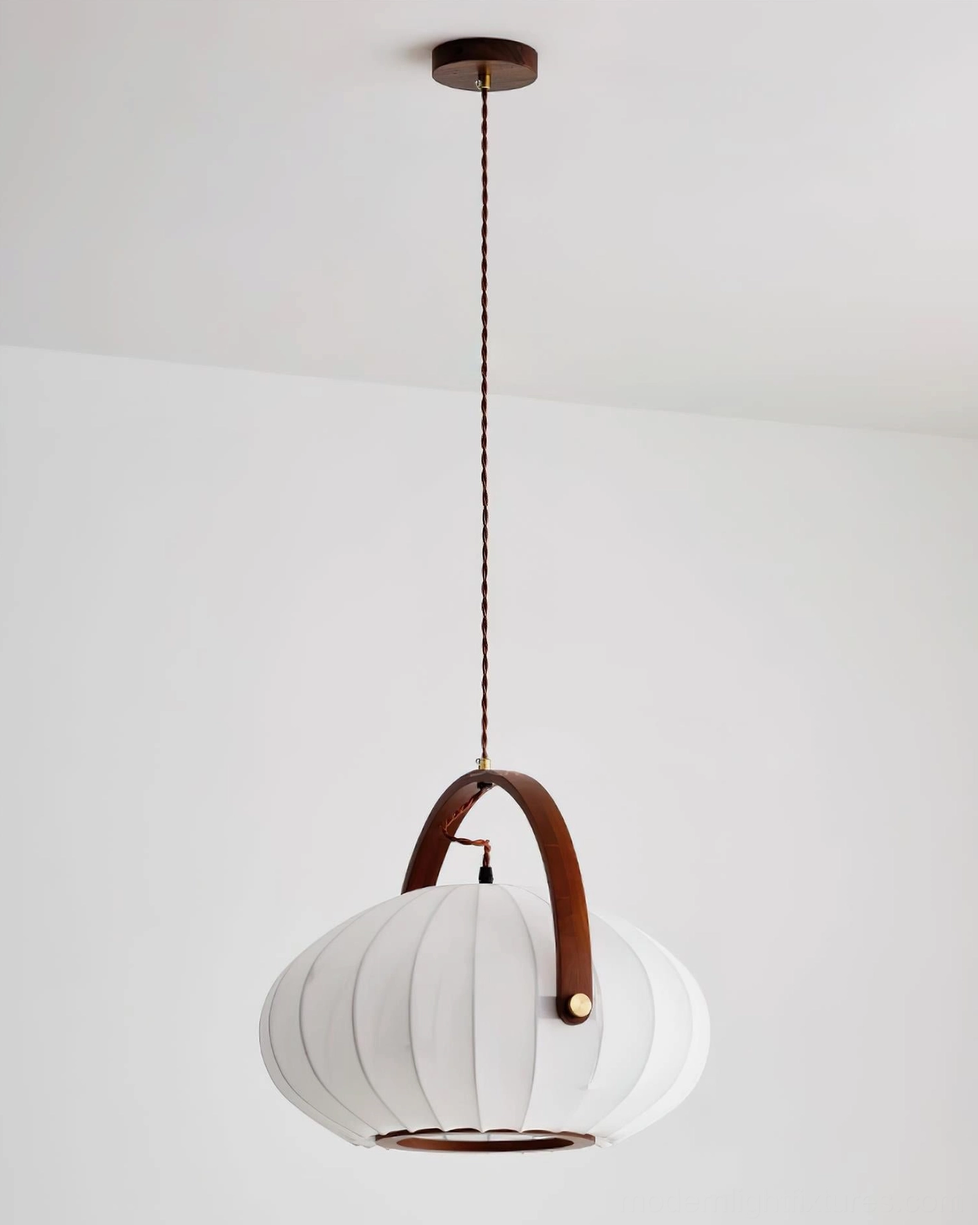 Modern walnut and white pendant lamp detail showing pleated fabric shade craftsmanship and wood accents