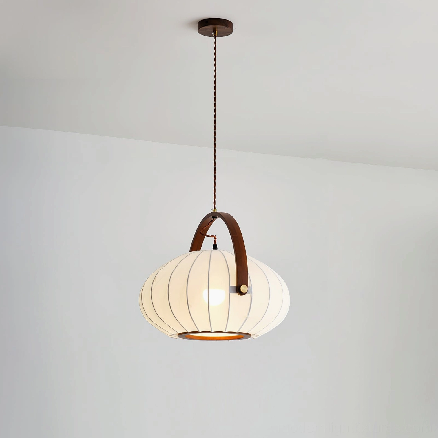 Antonio pendant lamp front view showing pleated white fabric shade with dark walnut wood carry handle