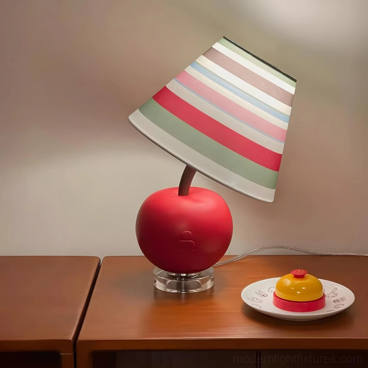 Red apple-shaped table lamp on wooden bedside table with dessert plate, left side view bedroom styling
