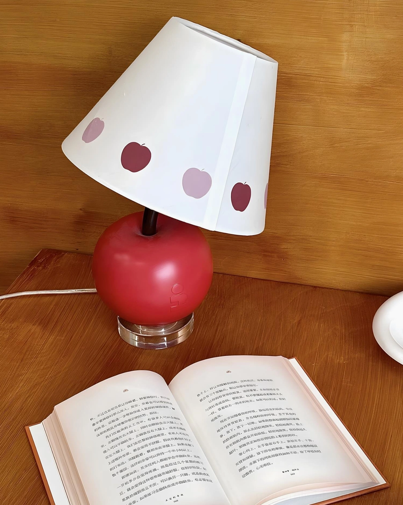 Apple-shaped table lamp with sculptural resin base and clear acrylic platform, contemporary minimalist lighting fixture