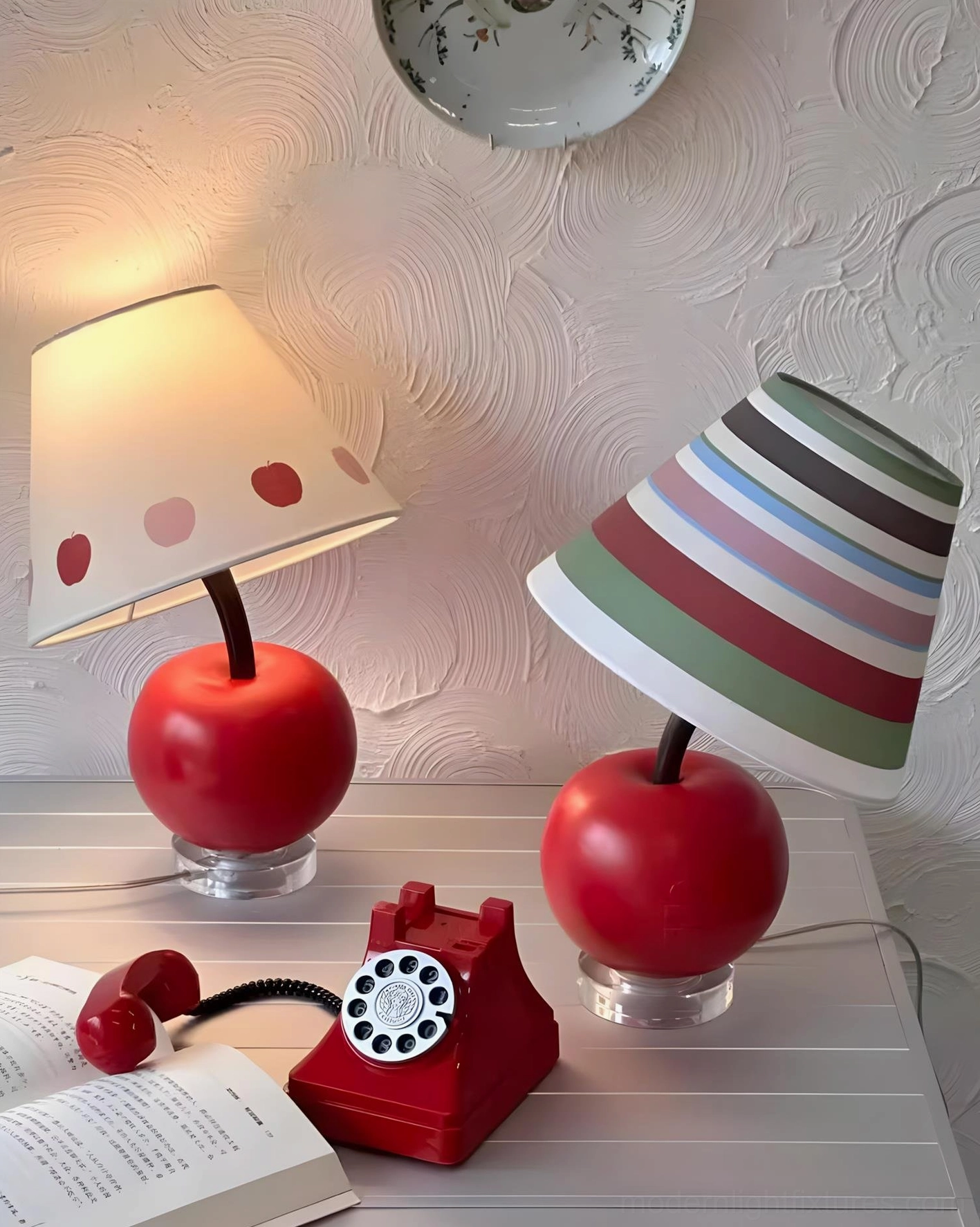 Two apple-shaped table lamps with textured wall bedroom desk setup, vintage telephone and open book accessories