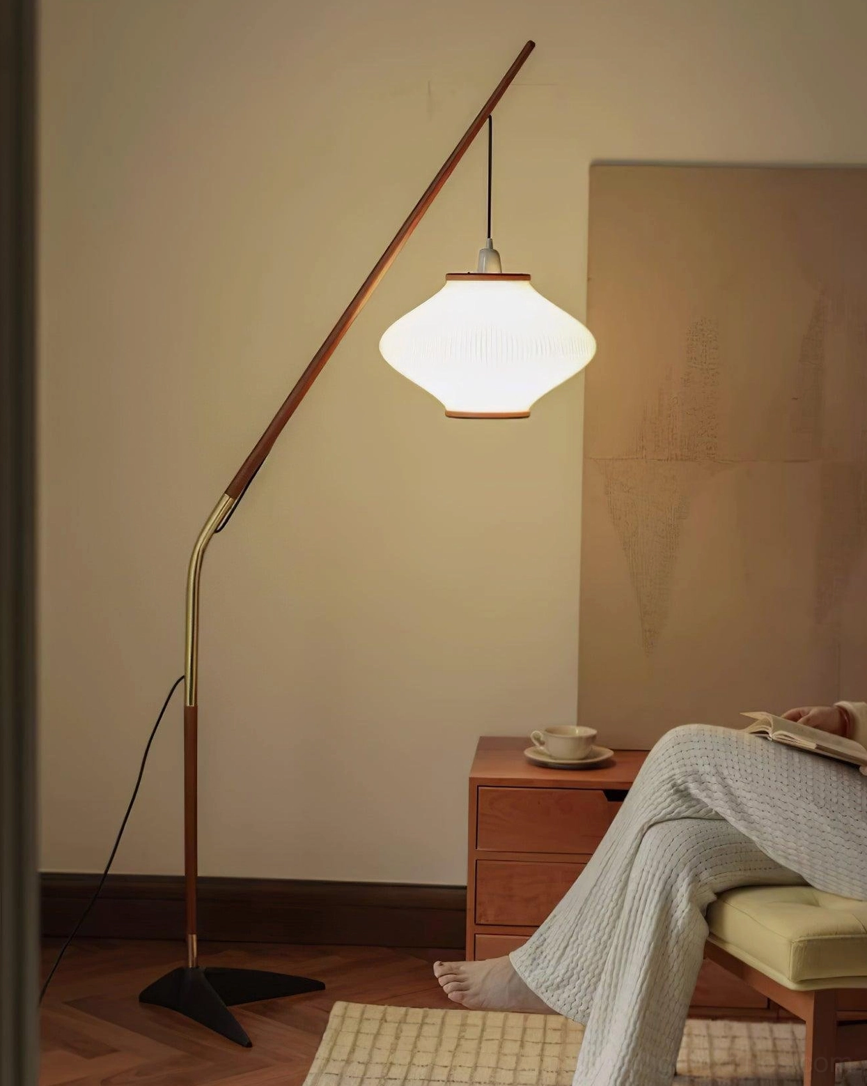 Arc floor lamp near reading chair and ottoman, functional bedroom accent lighting setup