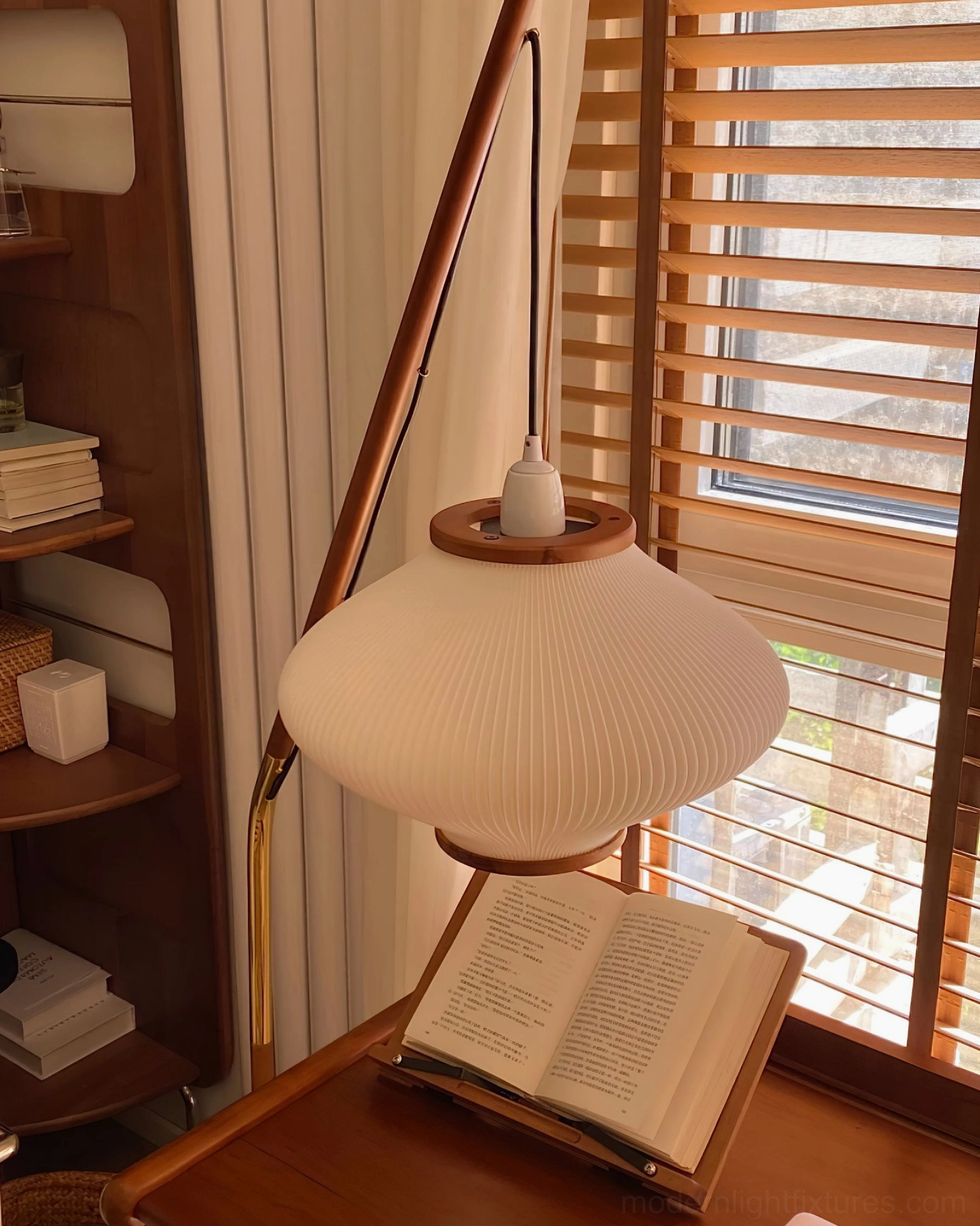 Arc floor lamp with brass accents gleaming in natural light, material quality showcase