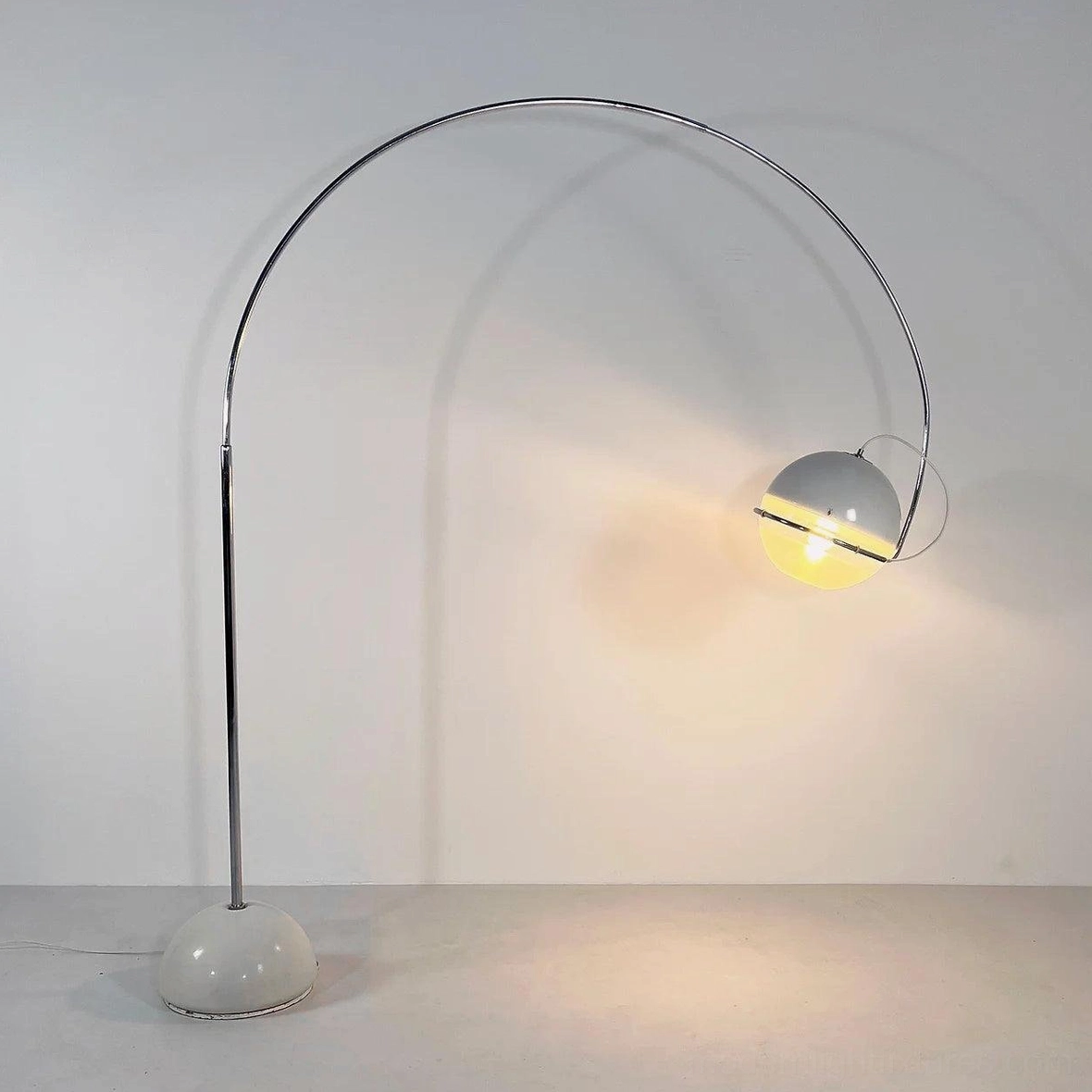 Arc floor lamp product photography showing complete fixture with white spherical shade and chrome base