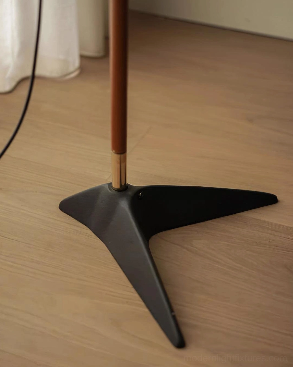 Modern arc floor lamp positioned in contemporary living room corner, accent lighting showcase