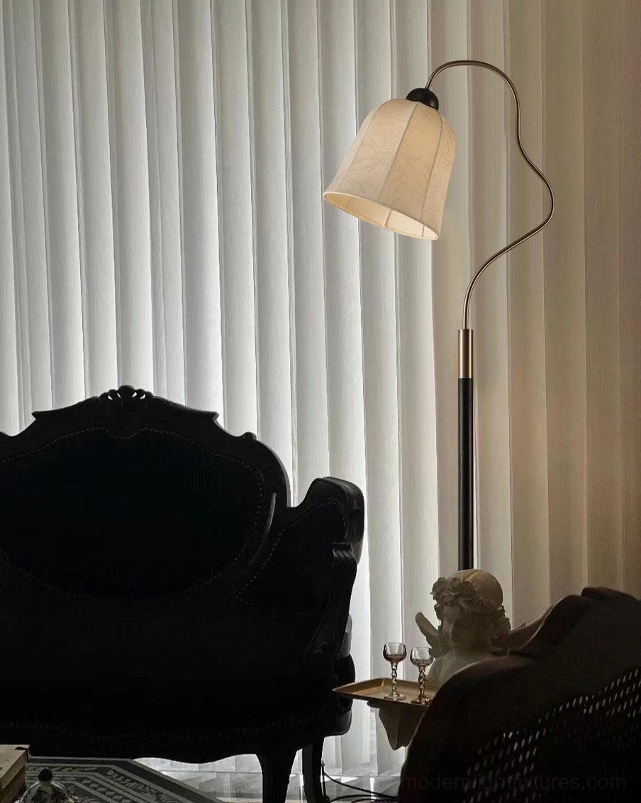 Arc floor lamp detail shot showing fabric shade texture and brass accents on walnut wood pole