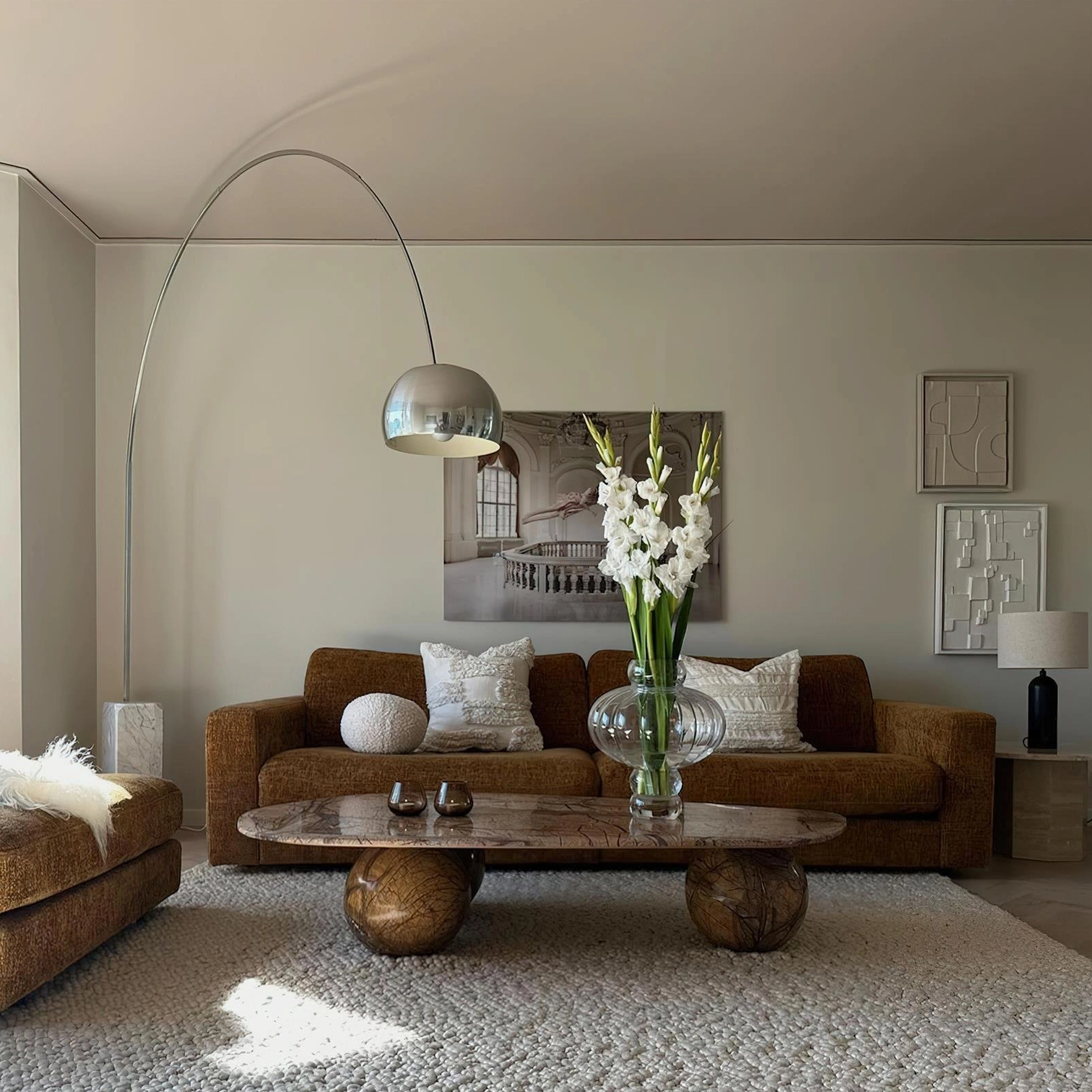 Modern arc floor lamp enhancing minimalist gallery wall display with artwork