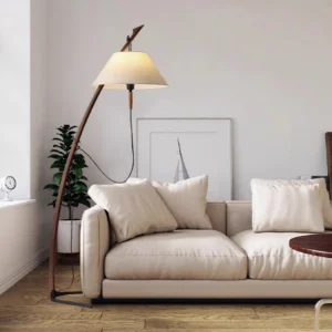 Contemporary arc floor lamp eye-level in modern living room with neutral sofa and natural wood pole