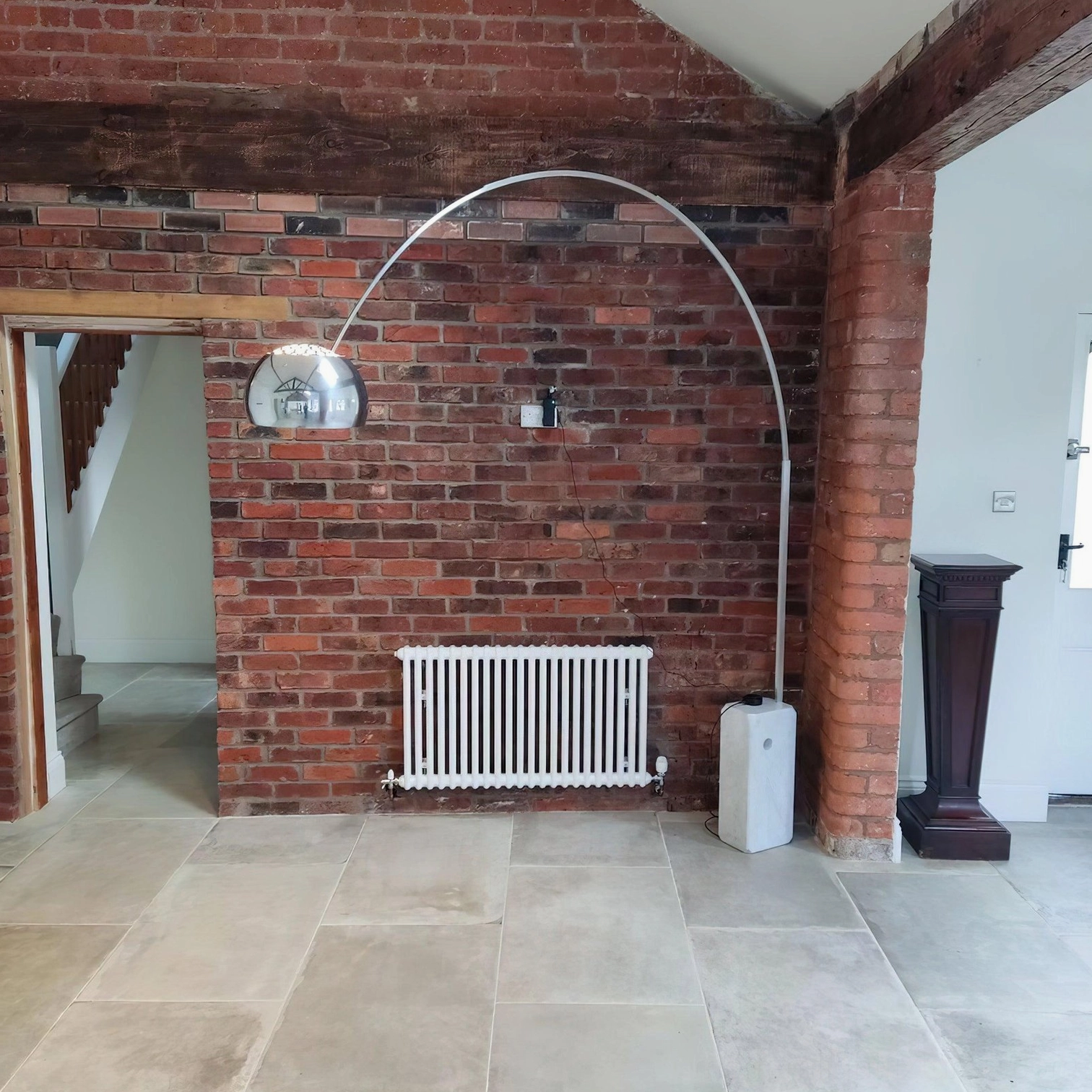 Modern arc floor lamp showing base weight and stability with marble construction