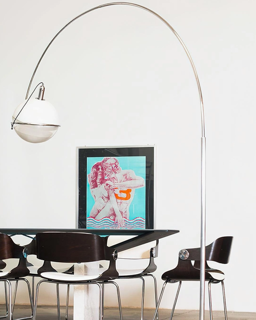 Arc floor lamp in modern dining room interior creating ambient light near table and wall art