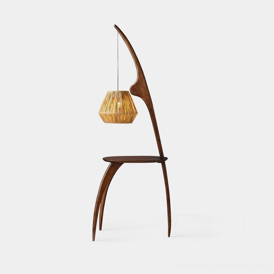 Minimalist arc floor lamp with walnut wood base and woven rattan shade, studio front view