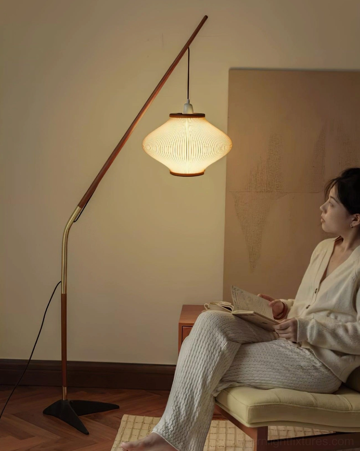 Woman relaxing on lounge chair beside arc floor lamp in reading corner, warm home lighting ambiance