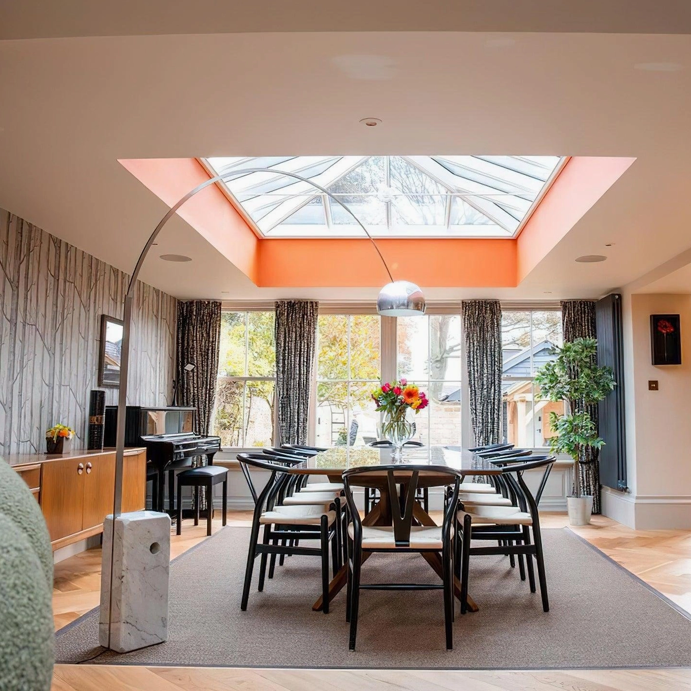 Arc floor lamp providing task lighting in modern reading corner with comfortable seating