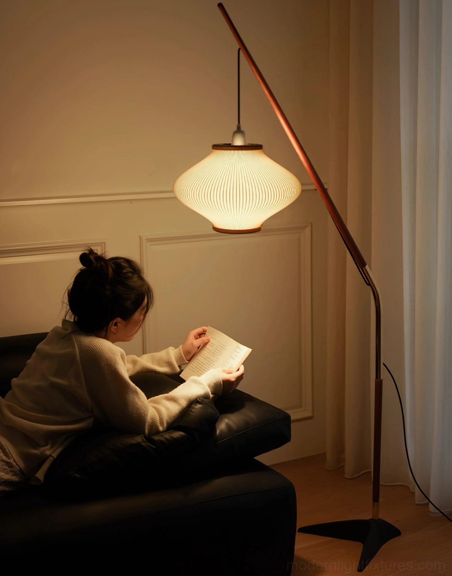 Woman reading under illuminated arc floor lamp, cozy living room setting with warm light ambiance