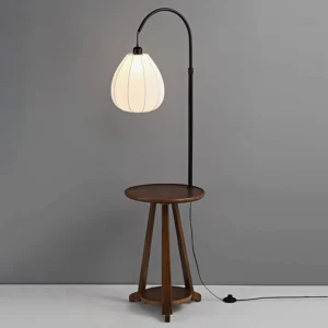 Arc floor lamp with integrated wood side table and lower shelf, black metal arc frame, studio lighting setup - mid-century modern design