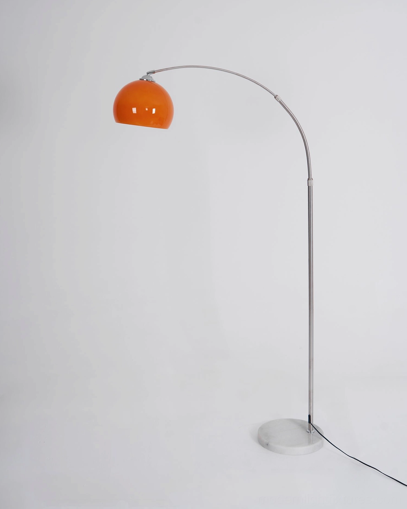 Arc floor lamp spherical shade organic curves chrome frame contrast