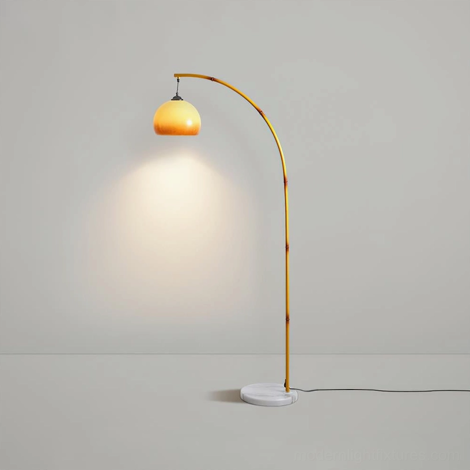 Yellow metal arc floor lamp with warm ambient illumination and white marble base - minimalist studio showcase