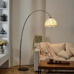 Modern arc floor lamp with black metal stand and beige ruffled shade in American style living room