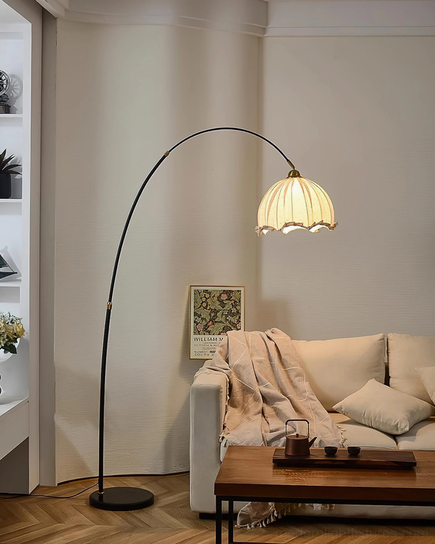 Contemporary arching floor lamp positioned over seating area ambient lighting
