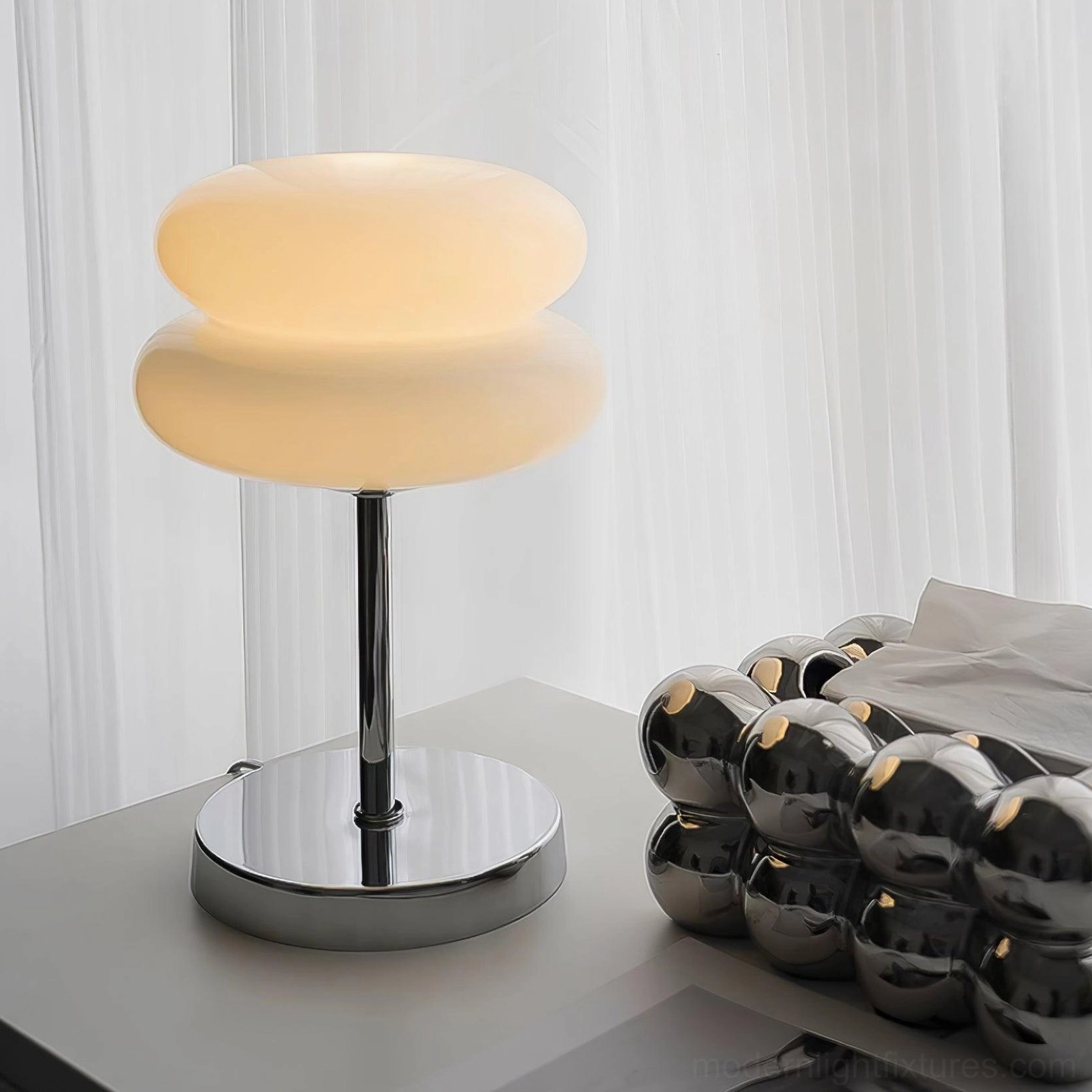 Modern glass table lamp with architectural spherical silhouette and refined proportions