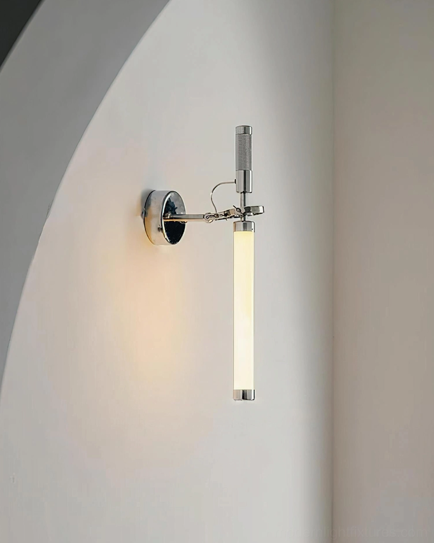 Ariane frosted glass tube wall sconce installed on curved archway in contemporary minimalist interior