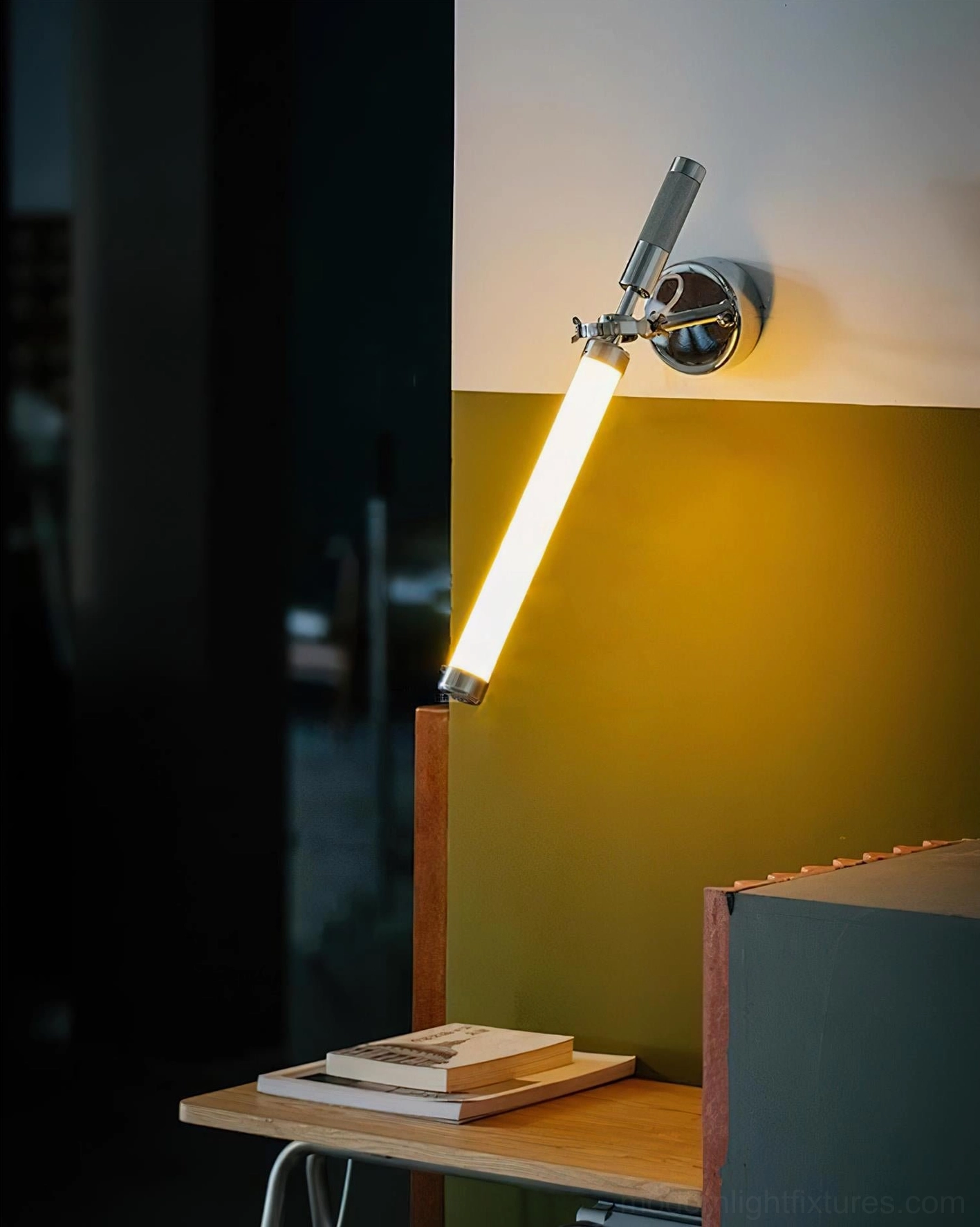 Industrial minimalist Ariane swing arm wall lamp used as task light in home desk study corner with warm glow