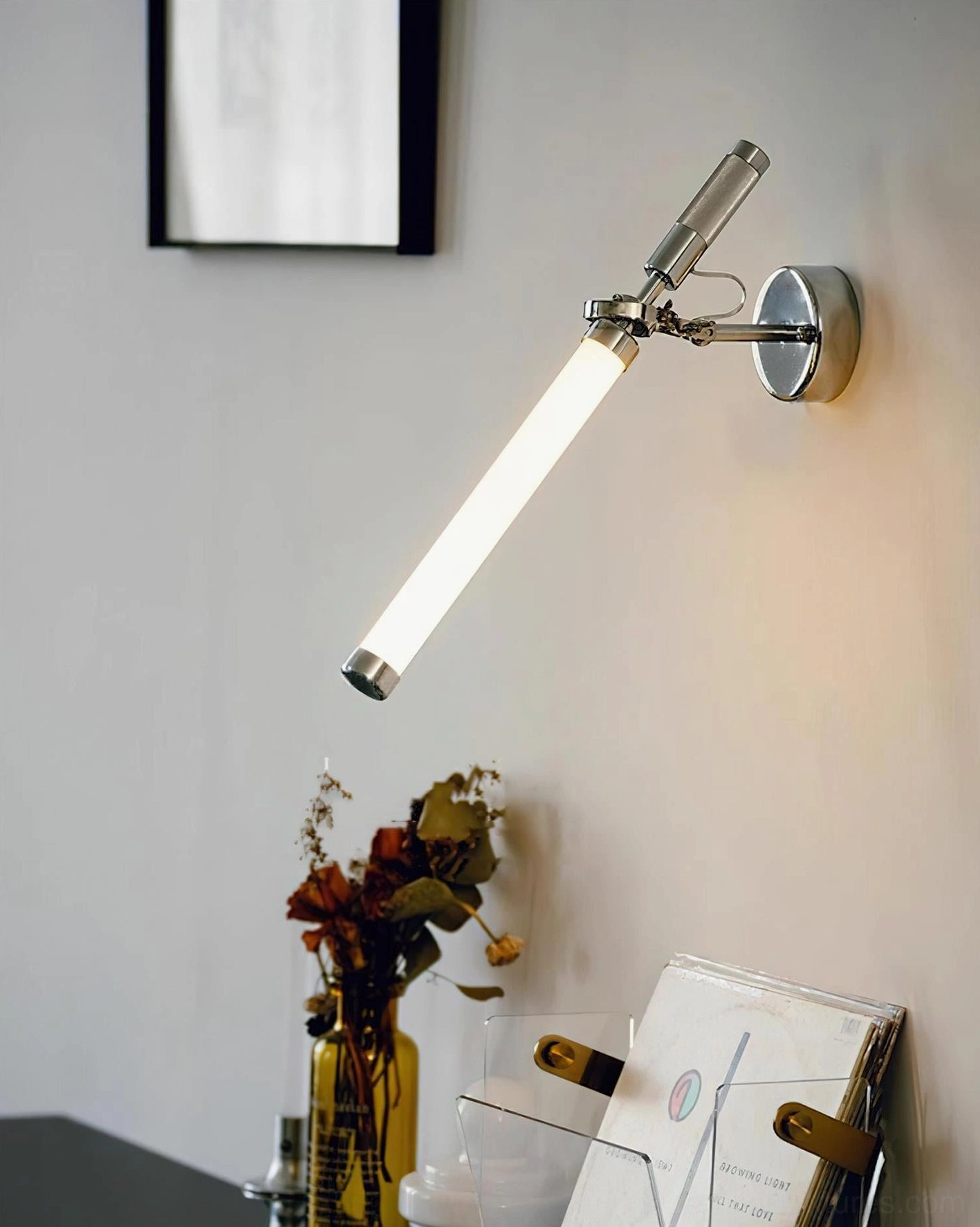 Industrial modern Ariane wall sconce with adjustable arm positioned in home workspace with warm task light