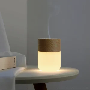 Cordless aroma diffuser night light emitting water vapor with warm glow in home interior setting