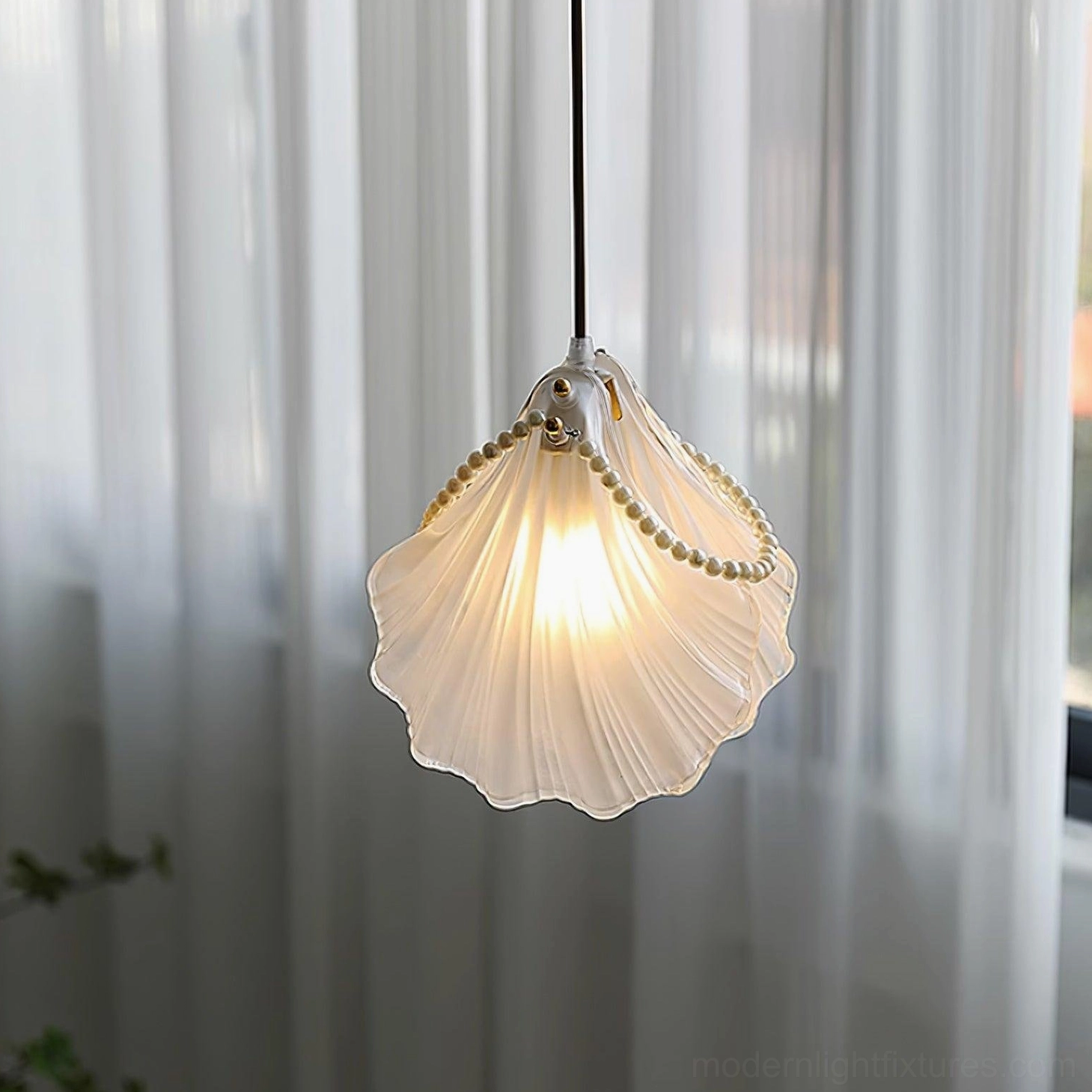 Art deco inspired shell pendant light with frosted glass and metallic bead trim accent