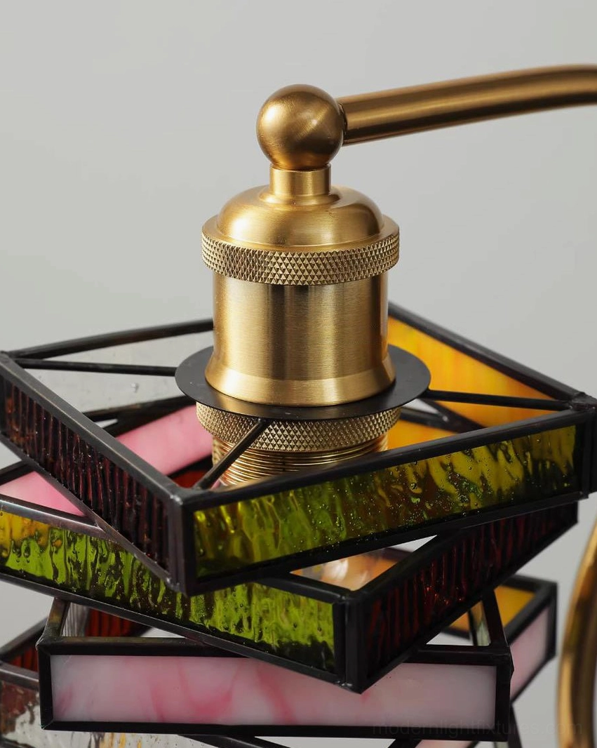 Vintage Art Deco stained glass table lamp featuring brass arm, walnut wood base and multicolor amber rust honey glass shade