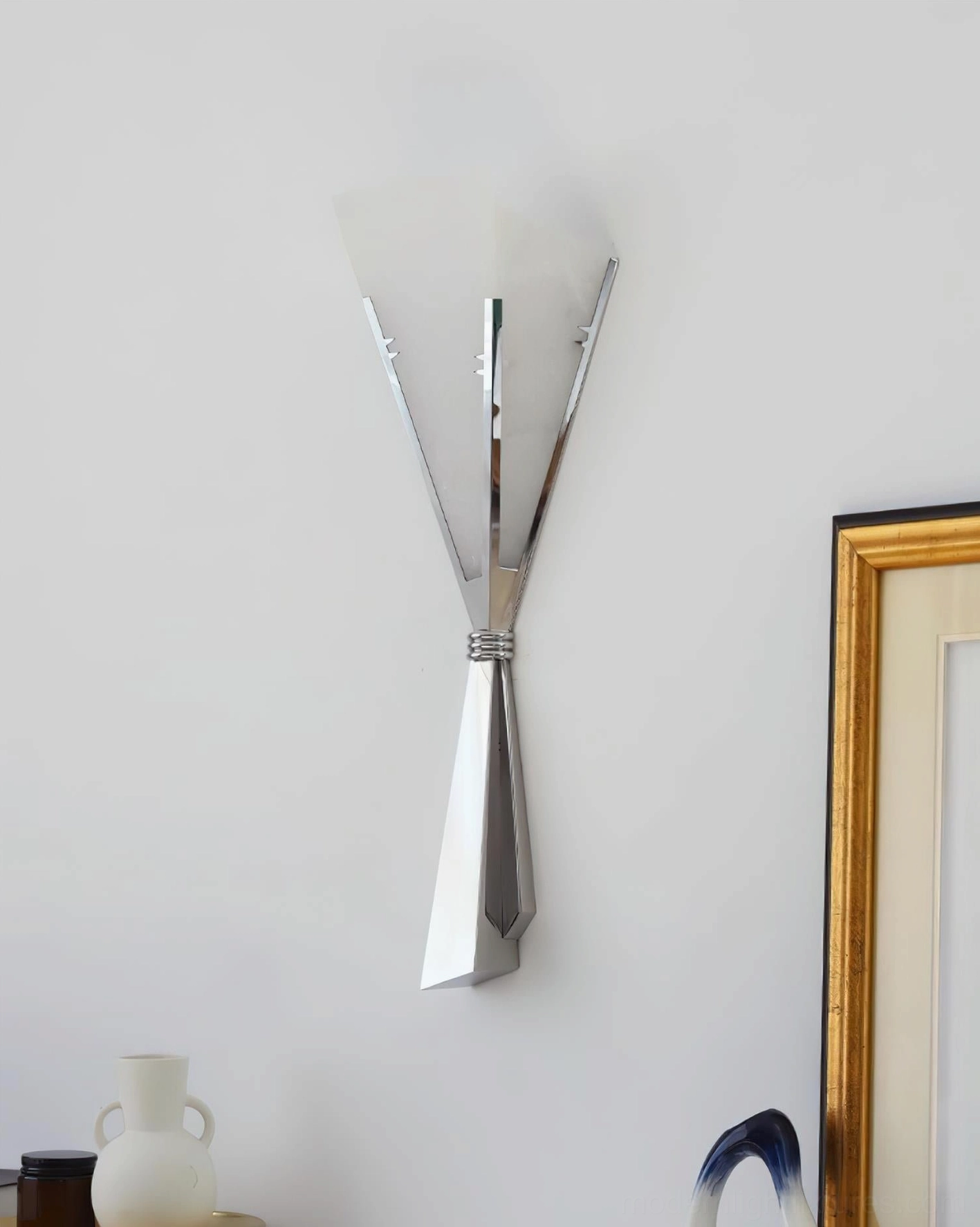 Art Deco wall sconce paired with contemporary home decor showing design versatility across multiple interior style applications