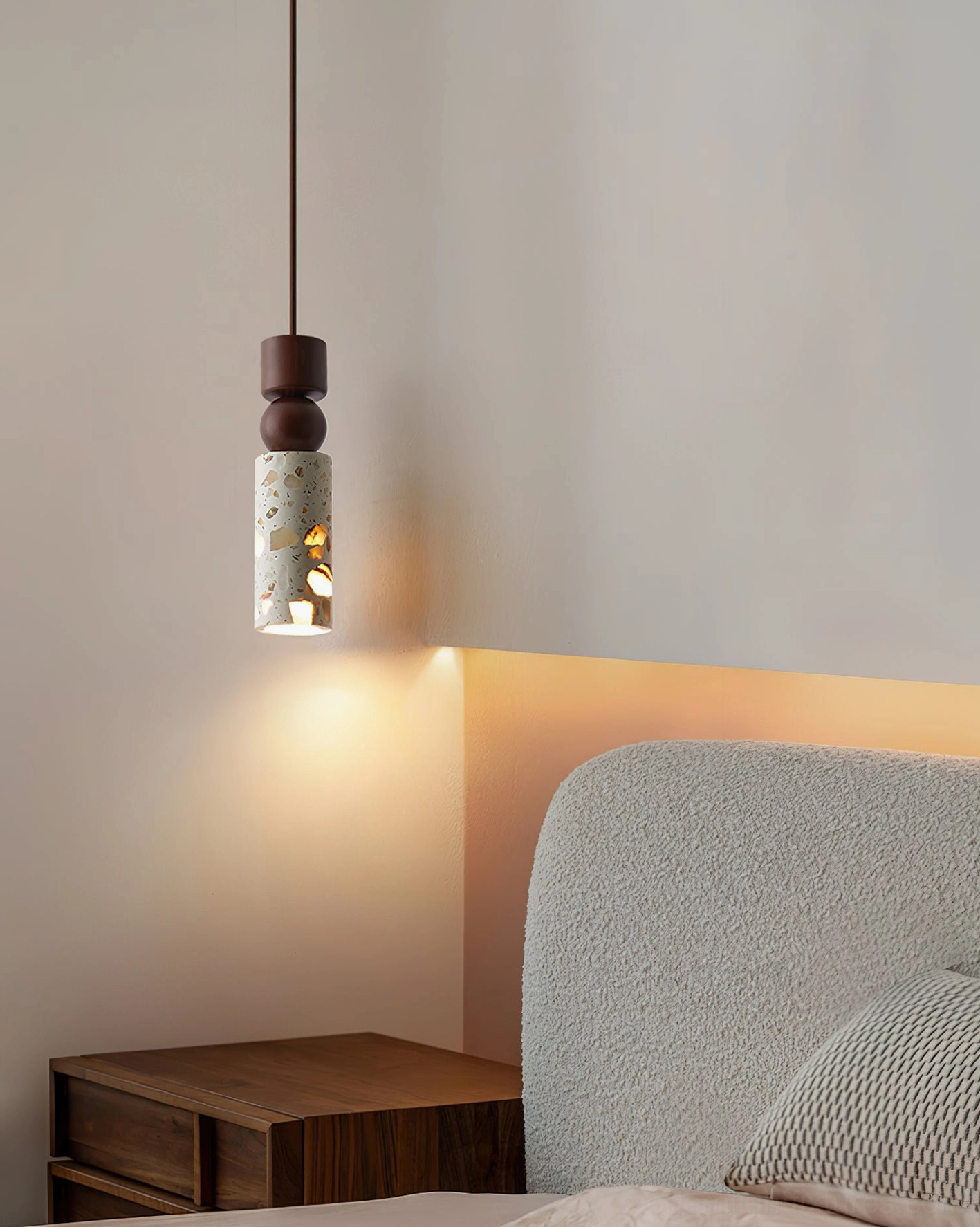 Artena pendant light above bedroom creating warm wall wash lighting and sculptural shadow effects