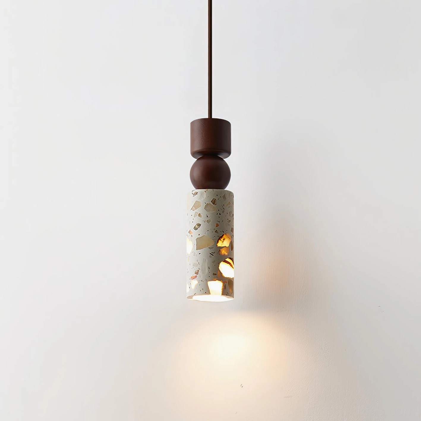 Artena terrazzo pendant light close-up studio shot showing dark brown and natural wood cap options