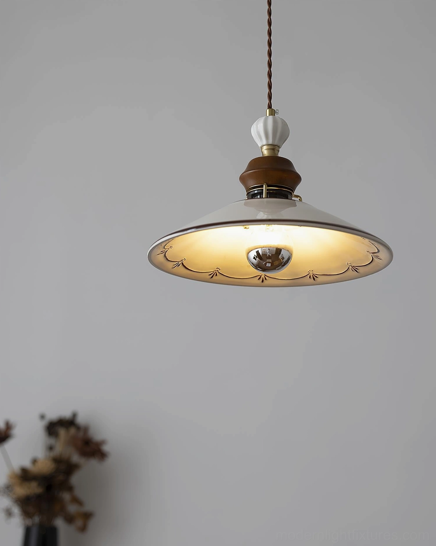Artisan ceramic pendant lamp showing scalloped edge detail and warm ambient lighting characteristics